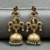 Gold plated bird dangler earrings with pearl and stone work.