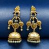 Gold plated bird dangler earrings with pearl and stone work.