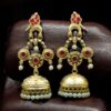 Gold plated bird dangler earrings with pearl and stone work.