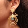 Gold plated star earrings with geometric stone dangler design.