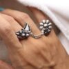 Silver plated half moon chain ring with flower and ghungroo design.
