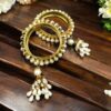 Traditional gold plated bangle with stone detailing.