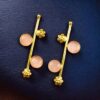 Gold plated flower earrings with stone work in western look alike design.