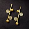 Gold plated flower earrings with stone work in western look alike design.