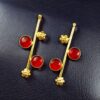 Gold plated flower earrings with stone work in western look alike design.
