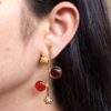 Gold plated flower earrings with stone work in western look alike design.