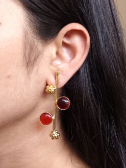 Gold plated flower earrings with stone work in western look alike design.