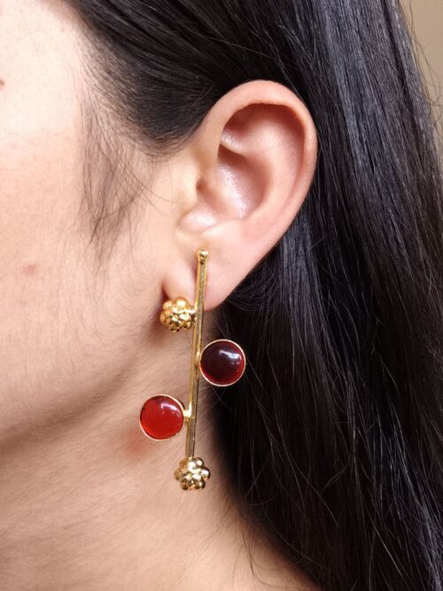 Gold plated flower earrings with stone work in western look alike design.