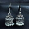 German silver pearl jhumka earrings with stone hook dangler design.