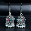 German silver pearl jhumka earrings with stone hook dangler design.