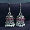 German silver pearl jhumka earrings with stone hook dangler design.