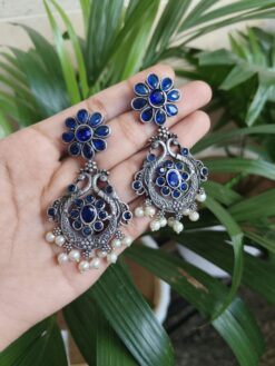 Silver Plated Peacock Dangler Earrings With Elegant Stone And Pearl Work Design