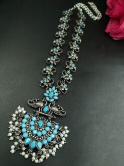 Beautiful silver-plated oxidized peacock necklace with stone and pearl work for party wear.