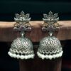 Oxidized silver floral art jhumka earrings with pearl work and vintage finish.