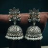 Oxidized silver floral art jhumka earrings with pearl work and vintage finish.