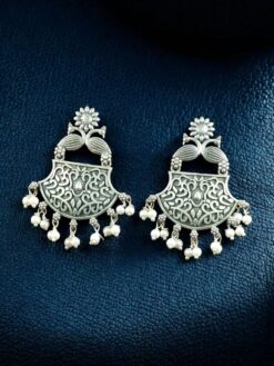 Oxidized peacock dangler earrings in silver look finish.