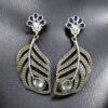 Oxidized silver replica peacock feather design dangler earrings for women.