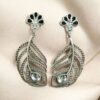 Oxidized silver replica peacock feather design dangler earrings for women.