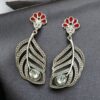 Oxidized silver replica peacock feather design dangler earrings for women.