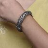 Openable oxidized silver replica floral art kada bangle for women.
