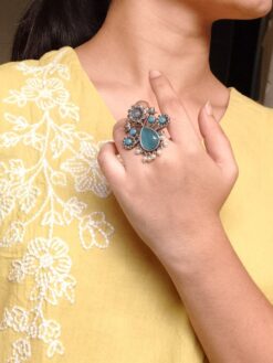 Silver replica adjustable flower design ring with stone and pearl work.