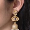 Gold plated jhumka dangler earrings with stone and pearl work