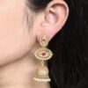 Gold plated jhumka dangler earrings with stone and pearl work