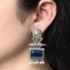 Two-tone stud earrings with Monalisa stone and pearl detailing