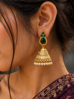 Luxurious gold plated jhumka earrings with sparkling stone embellishments and elegant pearl work, traditional Indian ethnic jewelry