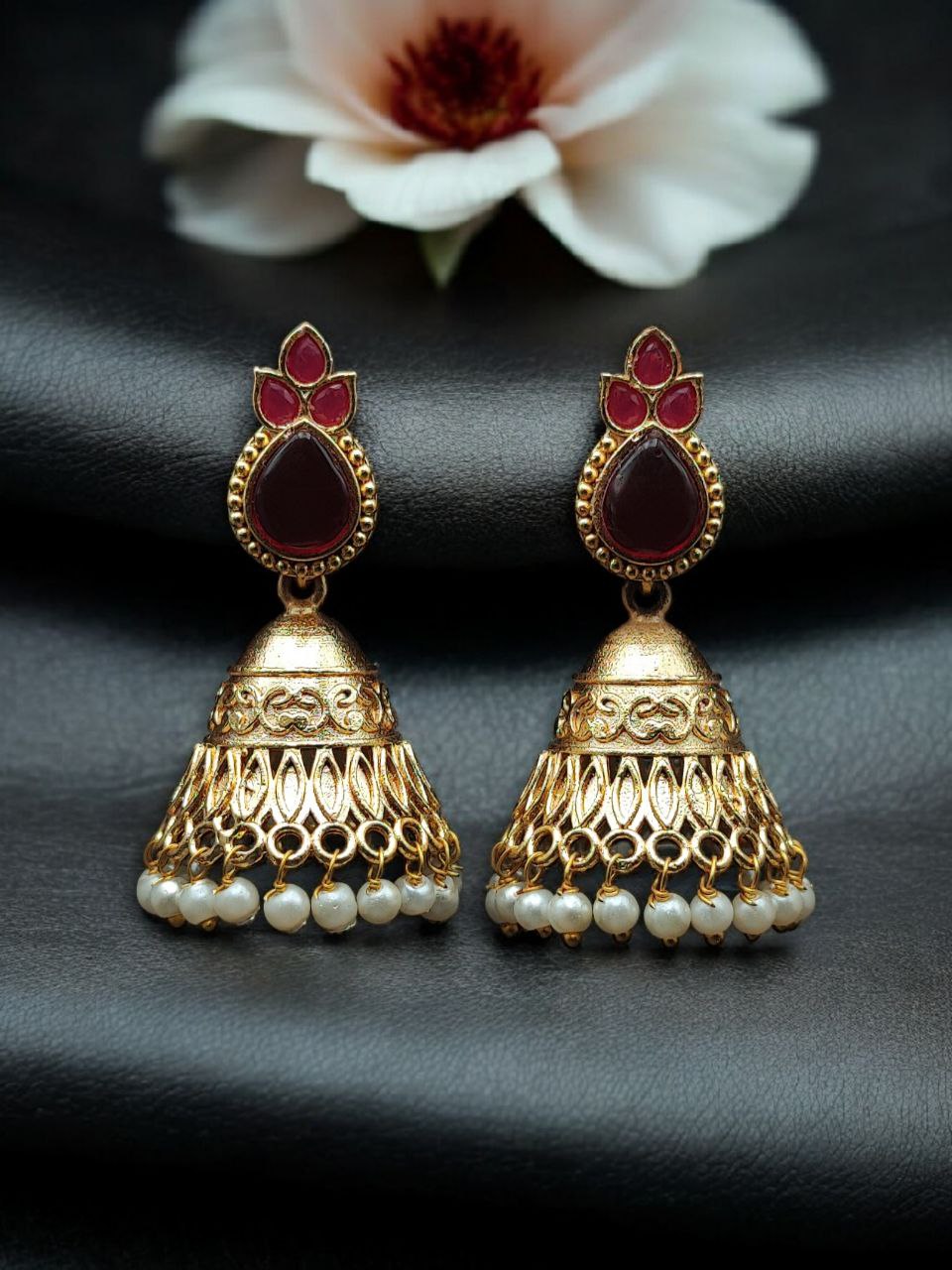 Luxurious Gold Plated Jhumka Earrings with Sparkling Stone Pearl Work 1 Luxurious gold plated jhumka earrings with sparkling stone embellishments and elegant pearl work, traditional Indian ethnic jewelry