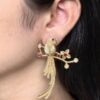 Gold plated parrot stud earrings with flower design and stone work
