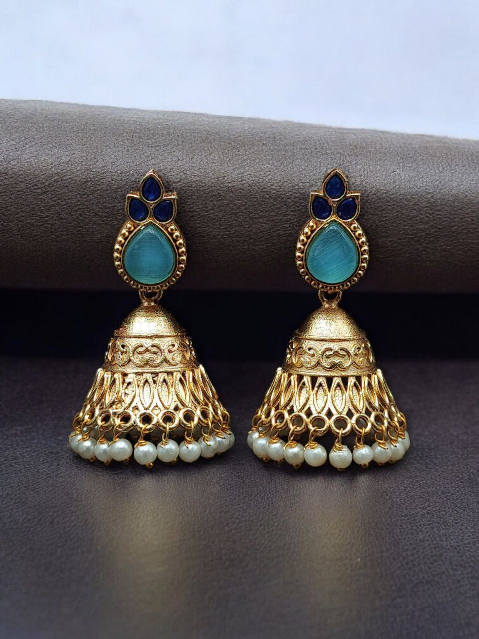 Luxurious Gold Plated Jhumka Earrings with Sparkling Stone Pearl Work 10 Luxurious gold plated jhumka earrings with sparkling stone embellishments and elegant pearl work, traditional Indian ethnic jewelry