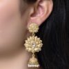 Gold plated flower design jhumka earrings with stone and pearl work