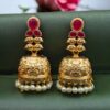 Gold plated floral art jhumka earrings with stone and pearl work
