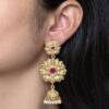 Gold plated flower design jhumka earrings with stone and pearl work